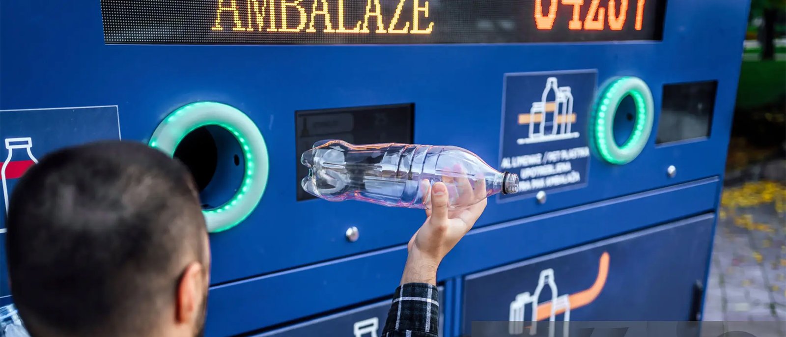 Bottle being inserted into vending machine